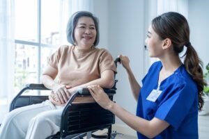Home asian nurse take care senior woman on wheelchair at nursing home